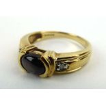 A 9ct yellow gold ring set hematite and two small diamonds, ring size N, 3.