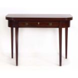 An early 19th century mahogany and strung side/tea table with a folding surface over a single