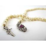 A single strand continuous cultured pearl necklace with 18ct white gold clasp set rubies and