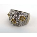 An 18ct white gold ring set small diamonds and citrine within an openwork foliate setting,