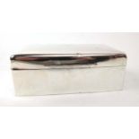 A silver cigarette box of cushioned rectangular form, maker RB, London 1913,