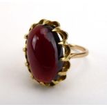 A 9ct yellow gold dress ring set oval cabochon garnet in an eight claw setting, ring size R 1/2, 5.