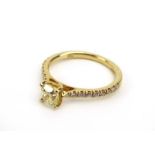 An 18ct yellow gold ring set cushion cut internally flawless fancy yellow diamond in a raised four