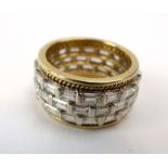 An 18ct yellow gold band ring set three rows of seventeen baguette cut diamonds in a brick setting,