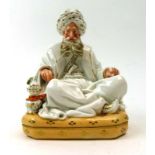 A 19th century Jacob Petit porcelain perfumer modelled as a seated Eastern gentleman and his pipe