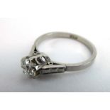 An early 20th century platinum ring set diamond in a raised six claw setting, stone approximately 0.