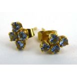 A pair of 18ct yellow gold ear studs, each set four pale blue stones, overall 1.