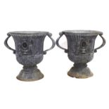 A pair of lead urns relief decorated in the Neo-Classical manner, h.