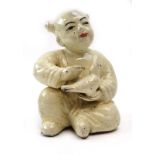 A Chinese glazed terracotta figure modelled as a seated child holding a bird, h. 14.