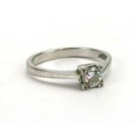 An 18ct white gold ring set single brilliant cut diamond in a square four claw setting,
