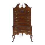 An American reproduction chest-on-stand, the eleven drawers over a shaped apron on cabriole legs,