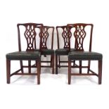 A set of four late 18th/early 19th century mahogany dining chairs with green leather seats on