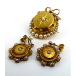 An early 19th century 15ct yellow gold memory brooch of circular form having bow design border set