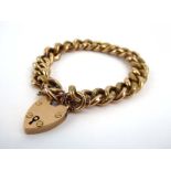 A 9ct yellow gold florally engraved curblink bracelet with heart shaped padlock clasp, 20.