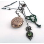 An early 20th century metalware figaro link necklace suspending a green enamel decorated pendant in