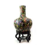 An early/mid 20th century Chinese floor vase of bottle form decorated in coloured enamels with