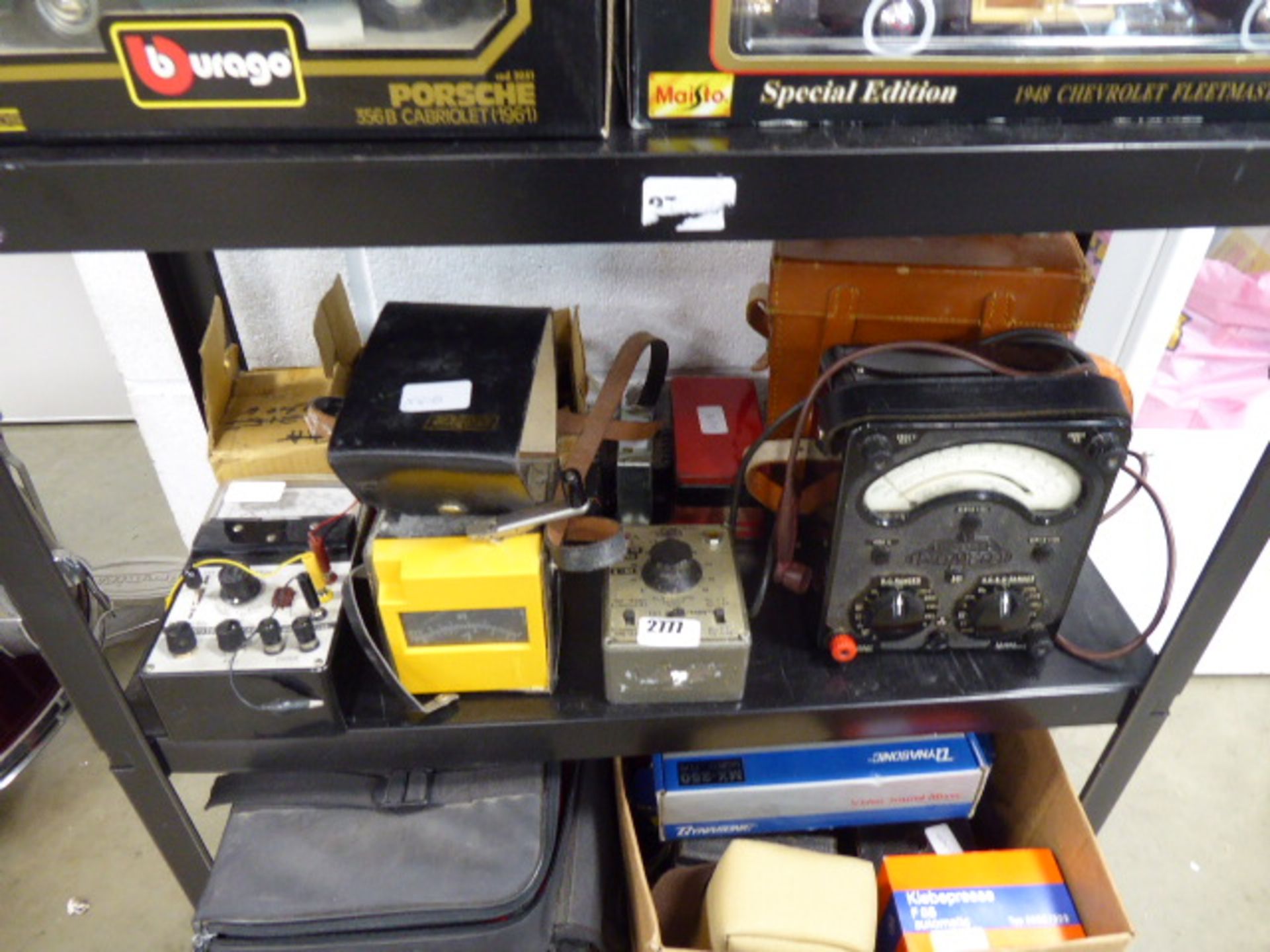 Shelf of assorted electrical testing equipment