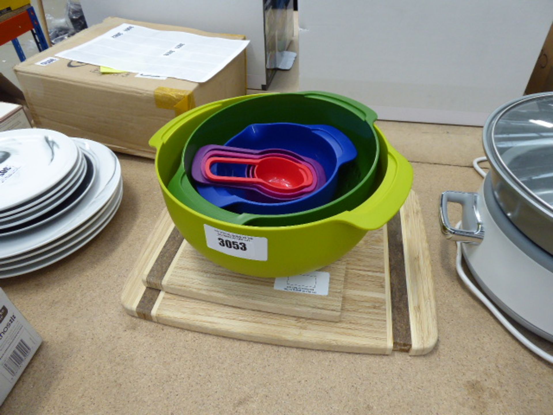 Two wooden chopping boards and a quantity of plastic mixing bowls