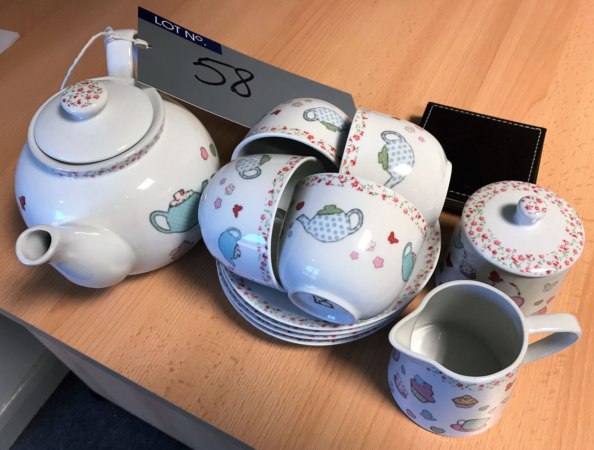 A Tea Set comprising: Teapot, 4 Cups and Saucers,