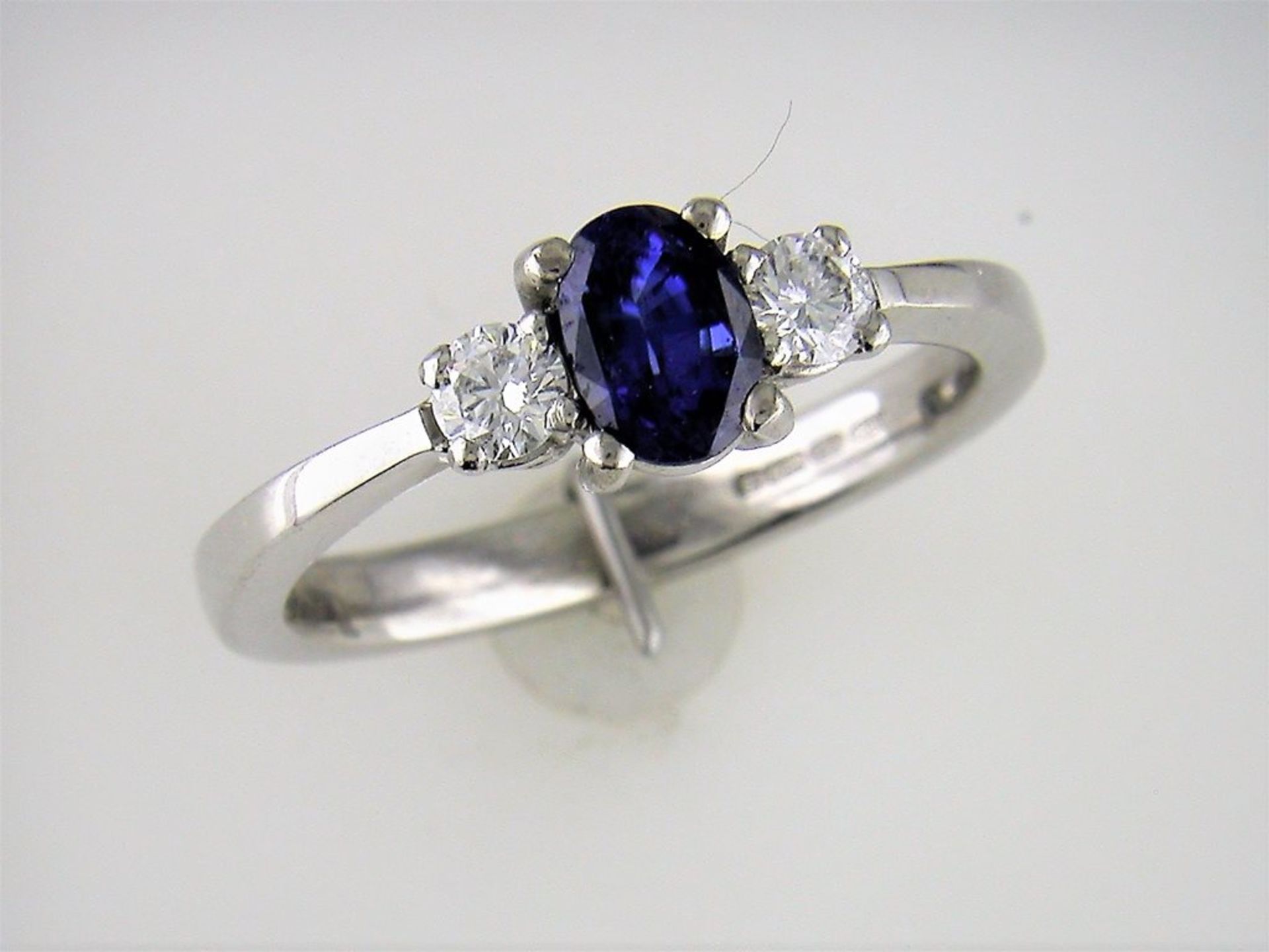 A Three Stone Sapphire and Diamond Ring
