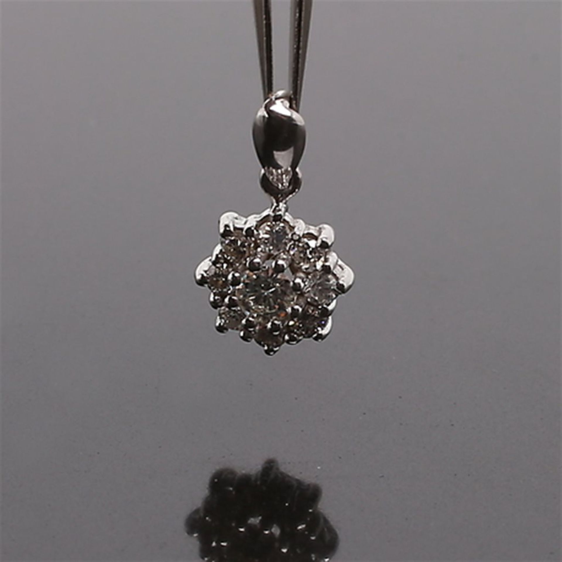 One pair earrings and pendant in white gold with diamonds totaling 1.41 ct.