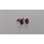 1.60ct ruby stud style earrings set in 9ct white gold. 7 x 5mm oval cut rubies ( glass filled )