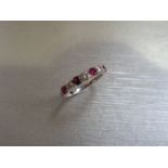 Ruby and diamond eternity style band ring with 4round cut rubies and 3 brilliant cut diamonds, 0.