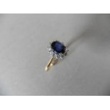 0.80ct sapphire and diamond cluster ring set with a oval cut (glass filled) sapphire which is