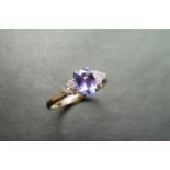 0.80ct tanzanite and diamond dress ring. Oval cut ( treated ) tanzanite with 3 small brilliant cut