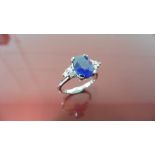 2.40ct Sapphire and diamond dress ring. Oval cut ( glass filled ) sapphire with 3 small brilliant