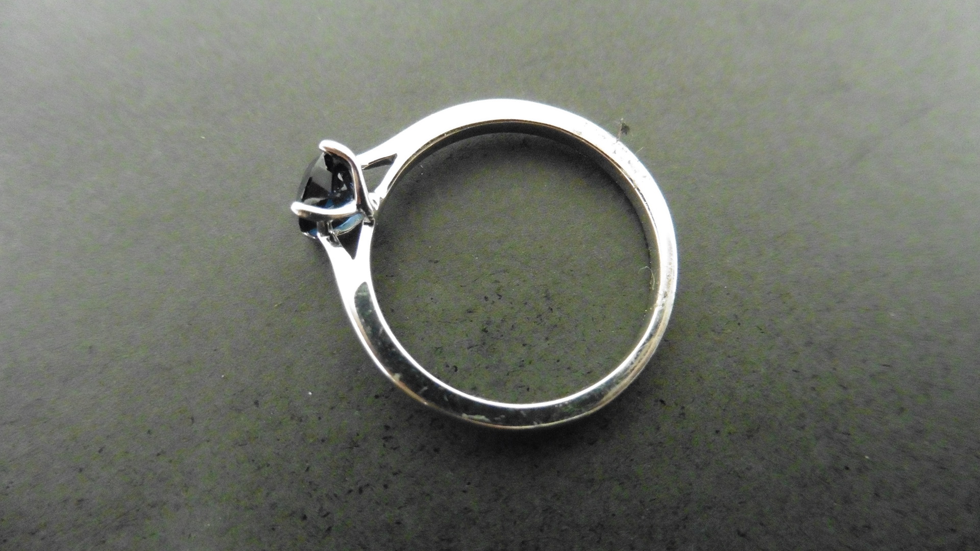 0.50ct solitaire style ring set with a round cut sapphire ( treated ) 5mm. Set in platinum with 4 - Image 3 of 4