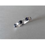 Sapphire and diamond eternity style band ring with 4round cut sapphires and 3 brilliant cut