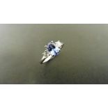 0.80ct tanzanite and diamond trilogy ring. 7x 5mm oval cut tanzanite (treated) with a small