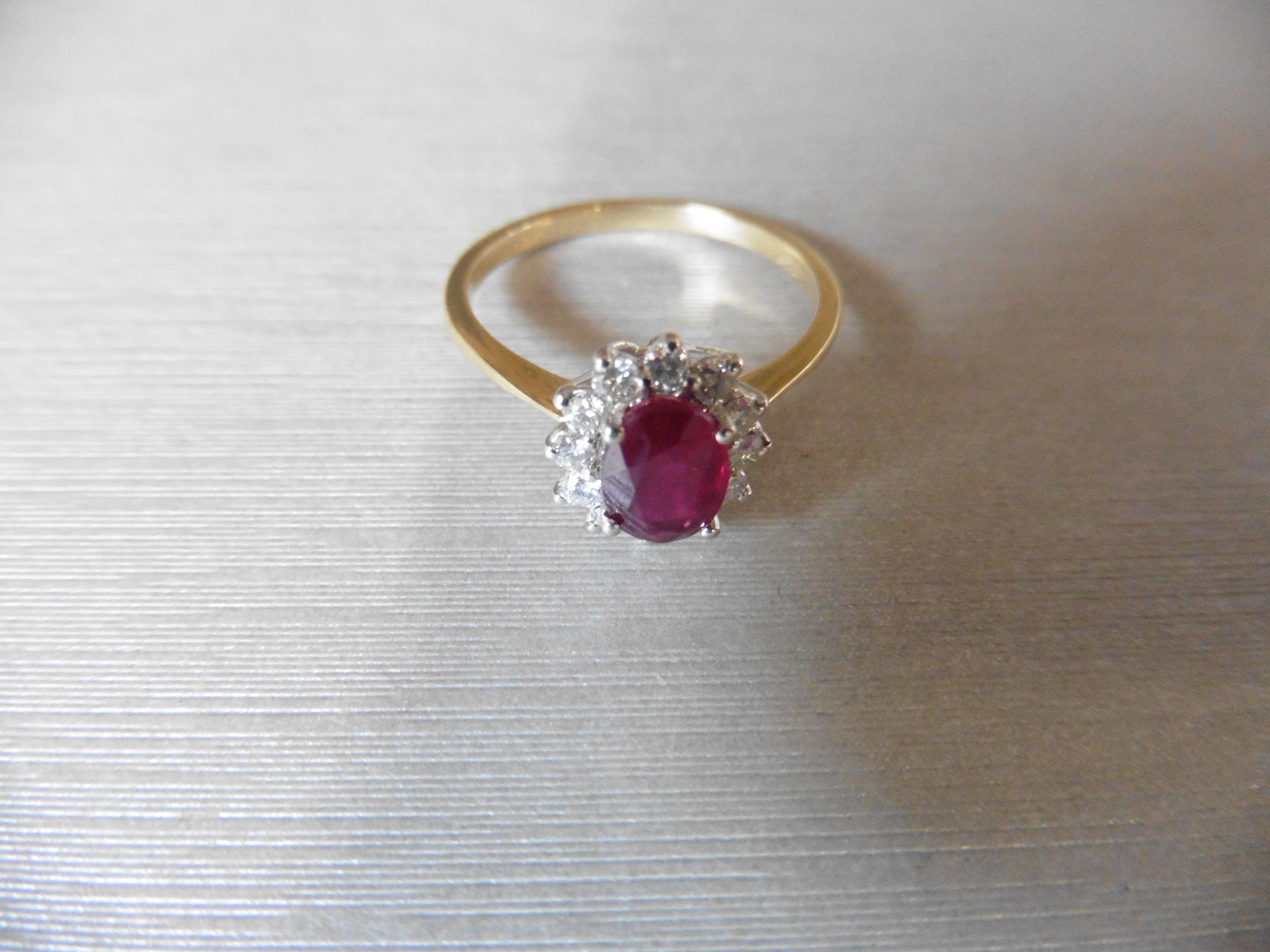 0.75ct / 0.30ct ruby and diamond cluster ring. Oval cut ( glass filled )ruby surrounded by small - Image 3 of 3