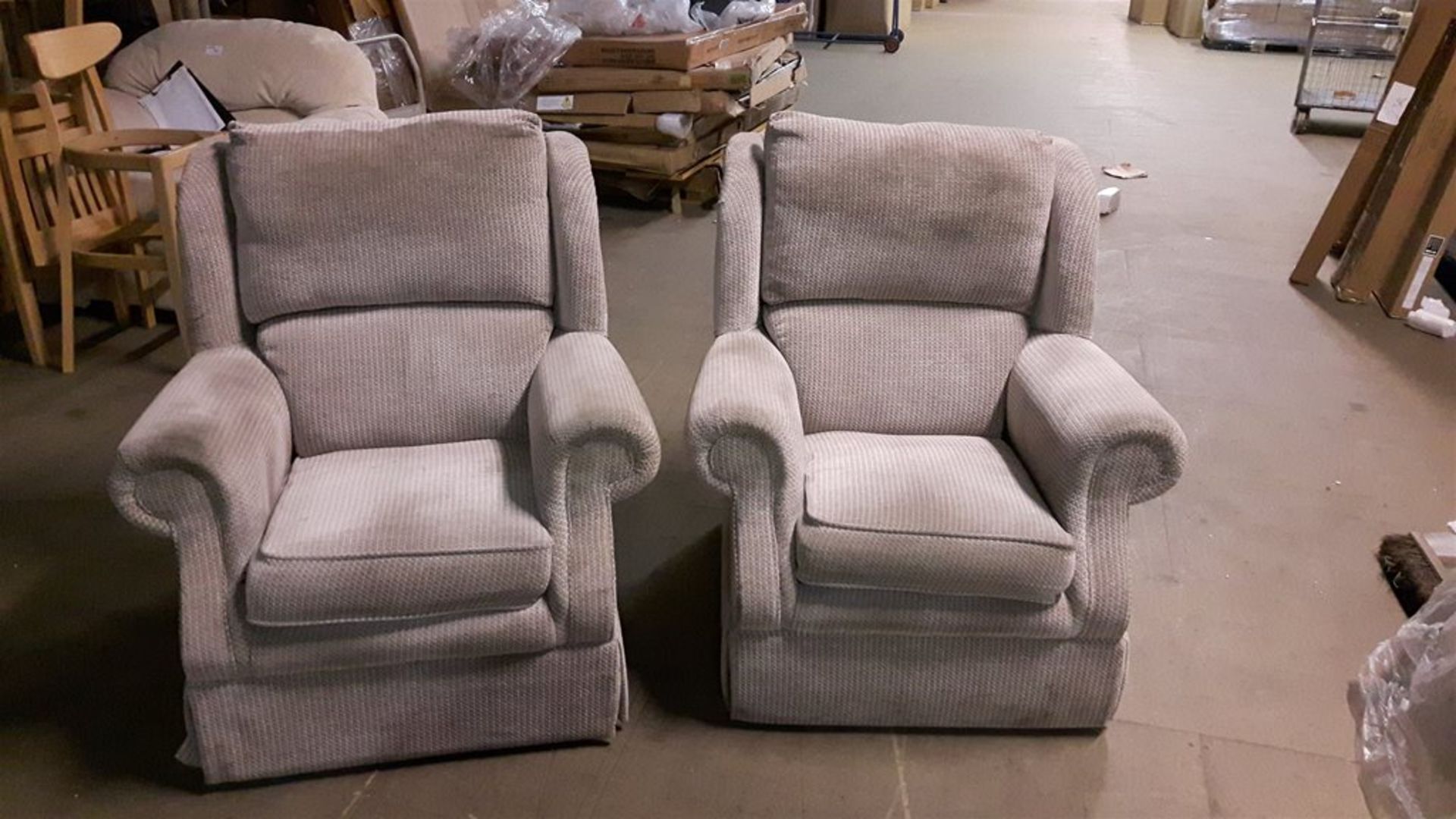 A pair of high back matching armchairs