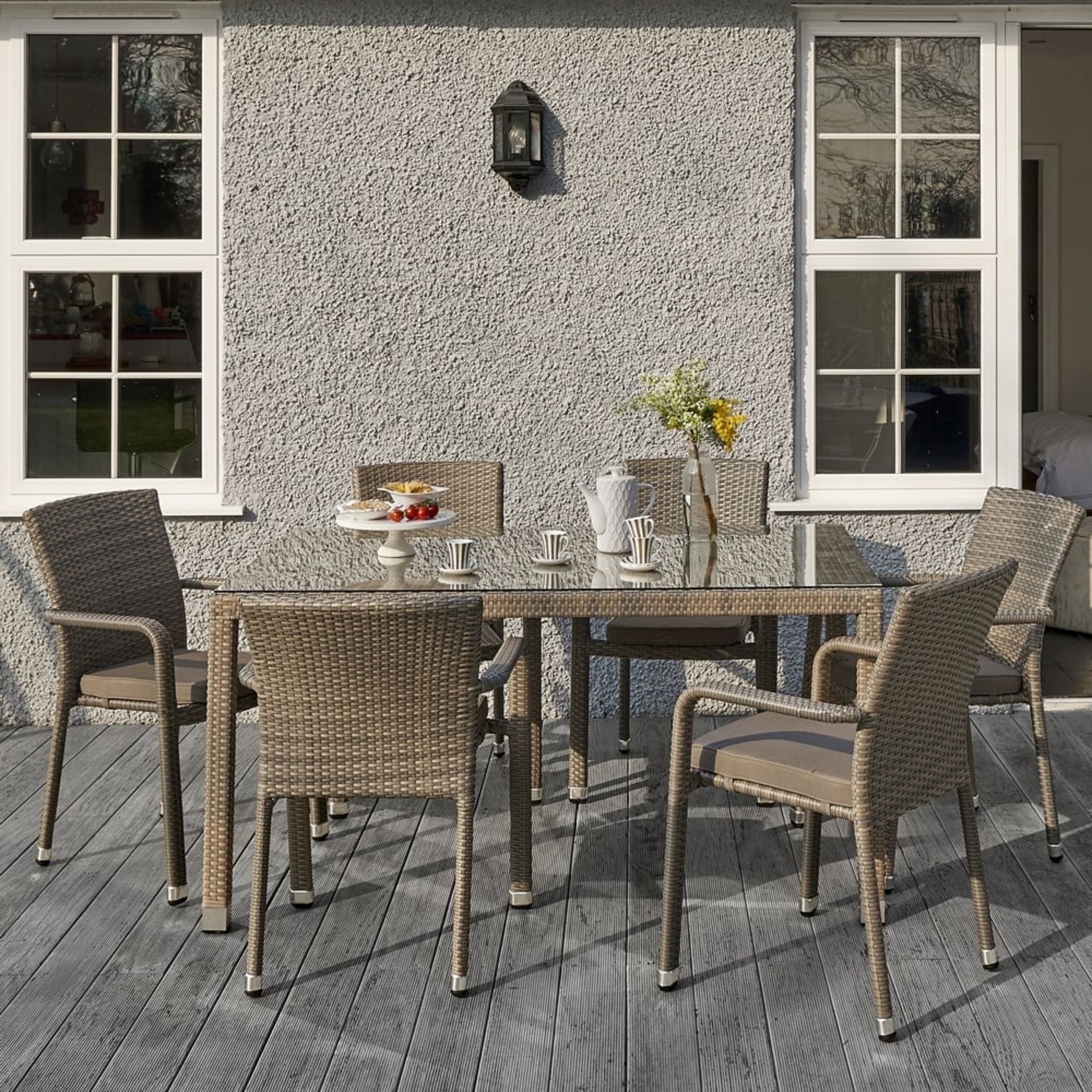 The Edinburgh rattan dining set in taupe consists of 6 stackable dining arm chairs with cushions.