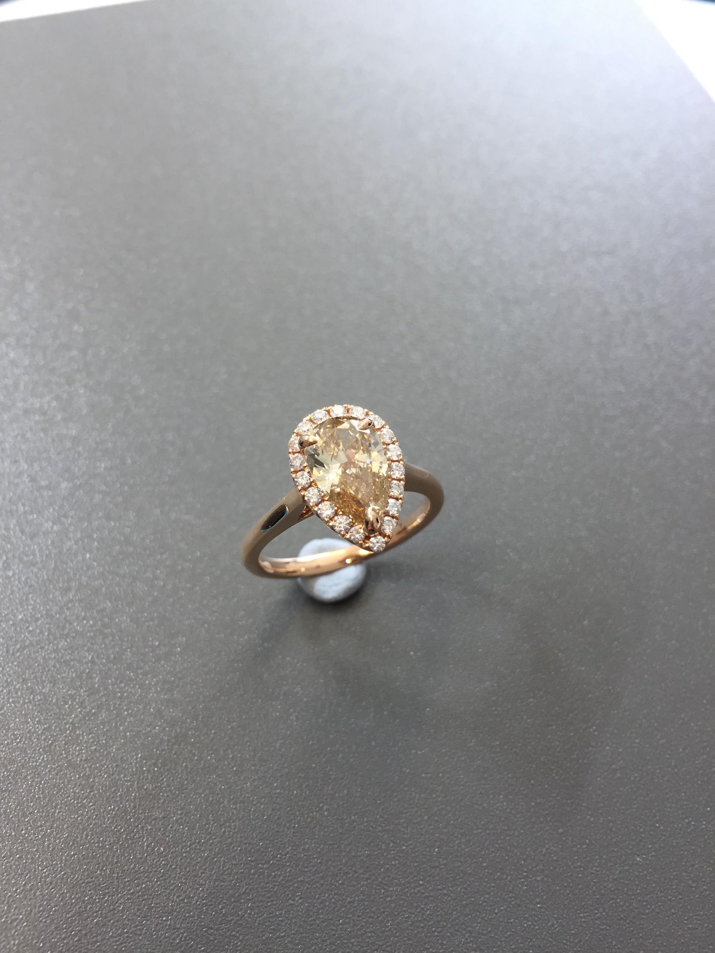 1.47ct pear shaped diamond set ring. Fancy yellow pear diamond, I1 clarity. Set in platinum. GIA
