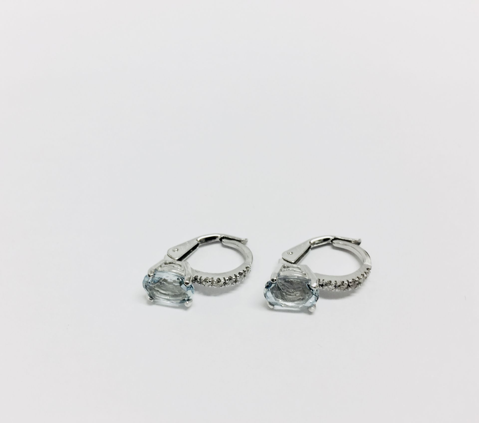 1.60ct Aqua marine and diamond hoop style earrings. Each is set with a 7x 5mm oval cut aqua ( - Image 3 of 3