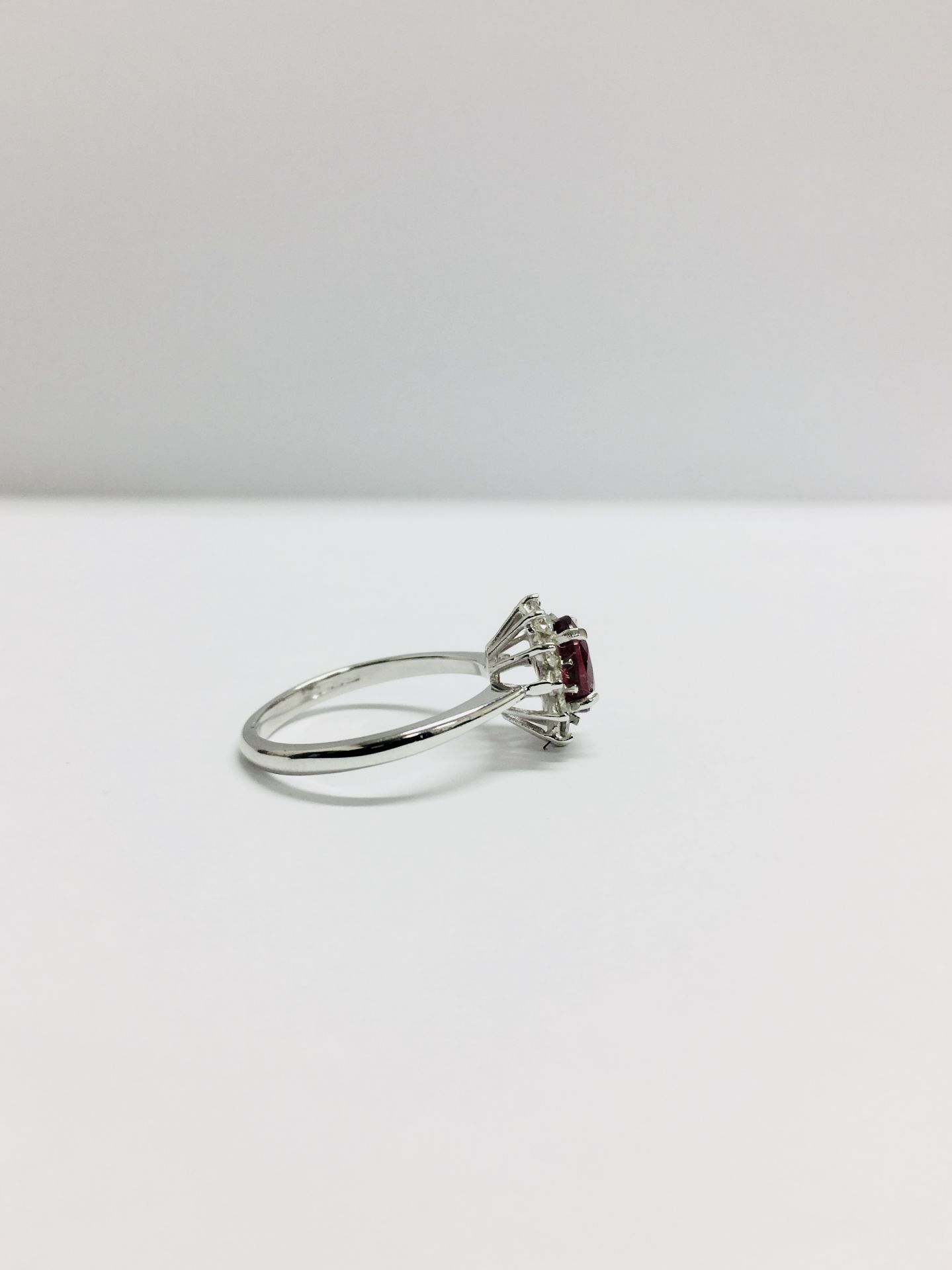 0.80ct Ruby and diamond cluster ring set with a oval cut(glass filled) ruby which is surrounded by - Image 4 of 5