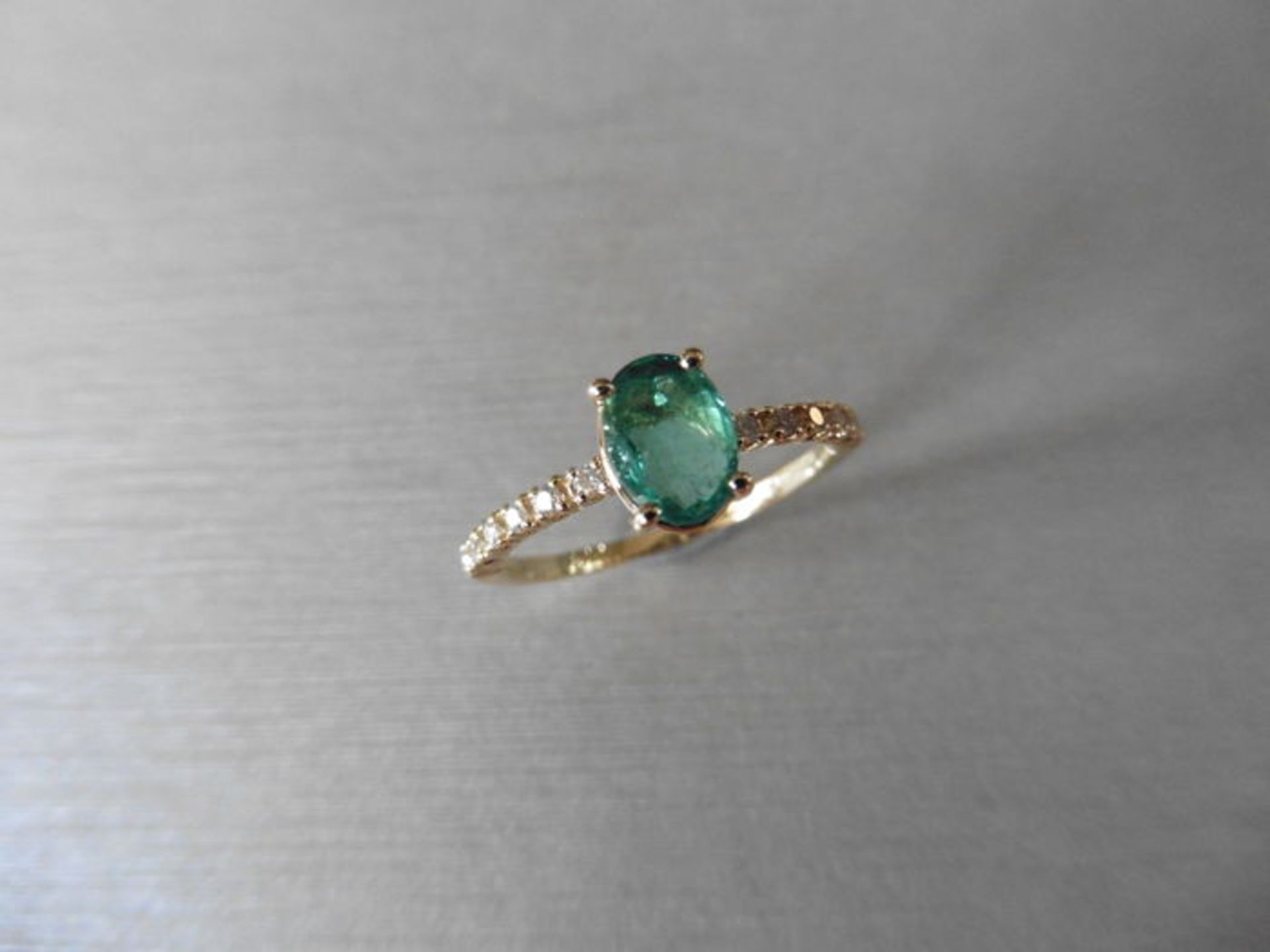 0.80ct / 0.12ct Emerald and diamond dress ring. Oval cut ( oil treated) emerald with small