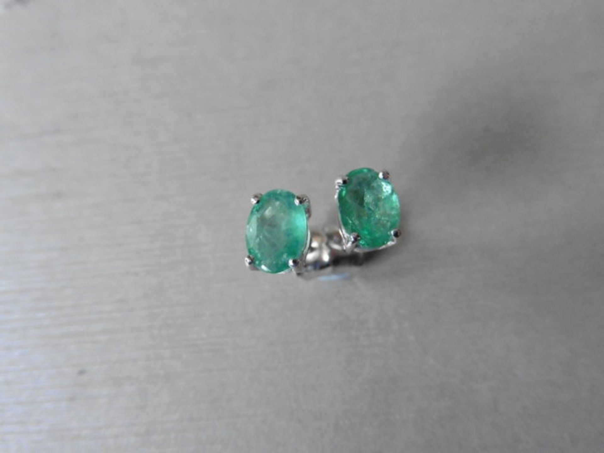 0.60ct emerald stud style earrings set in 9ct white gold. 7 x 5mm oval cut emeralds ( treated) set