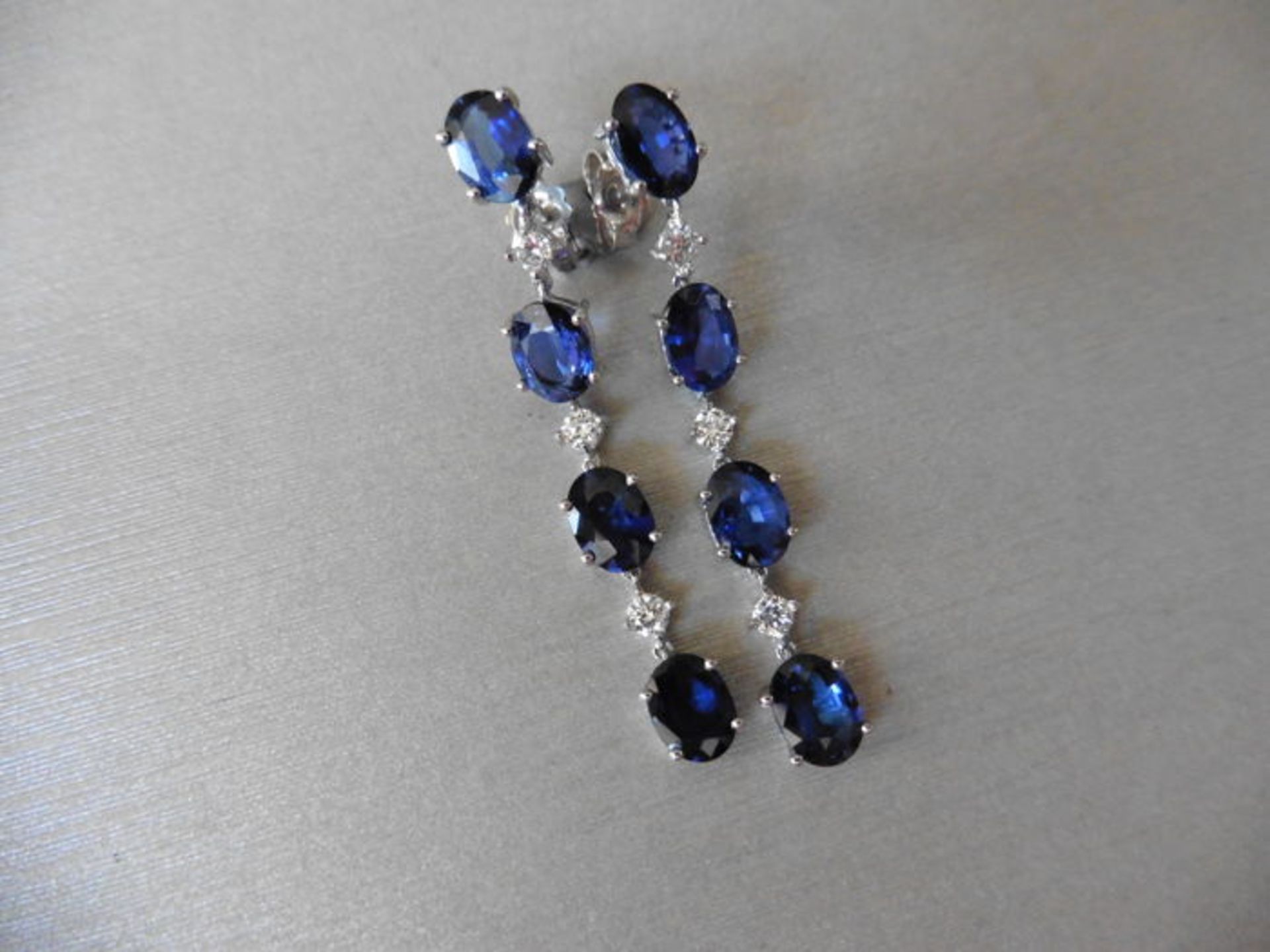 Sapphire and diamond drop style earrings set in 18ct gold. Each set with 4 oval cut ( treated)