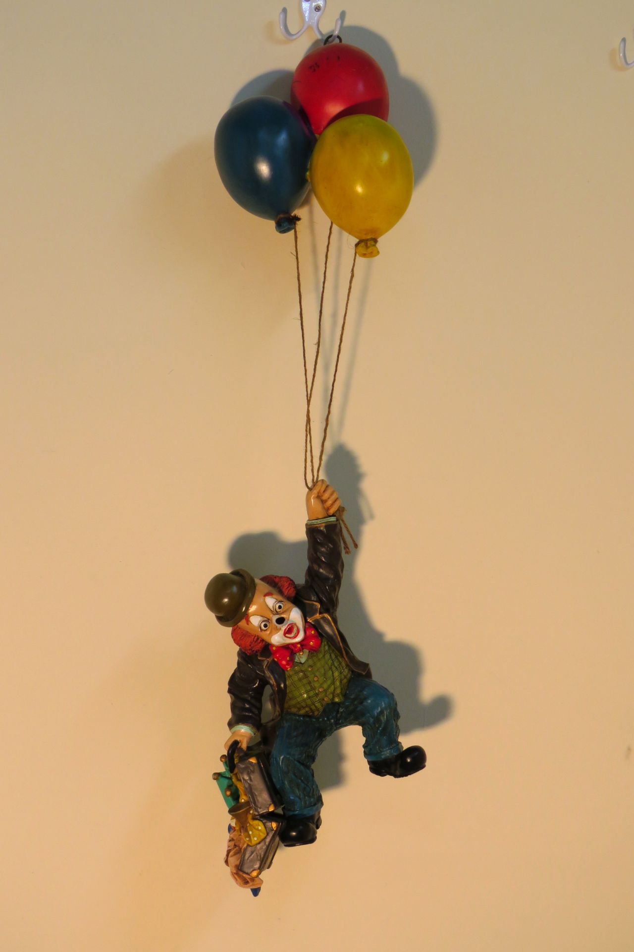 CAST RESIN CLOWN HANGING FROM BALLOONS