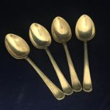 A vintage set of four sterling silver shell decorated teaspoons, Birmingham 1959 by Barker Brothers.