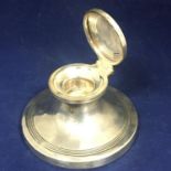 A George V sterling silver circular capstan type inkwell. Birmingham 1915 by Edward Souter Barnsley.