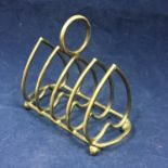 A Victorian sterling silver heart shaped toast rack. Birmingham 1886. Length 7cm. Weight 39.3g. -