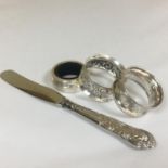 A group of various hallmarked silver items to include napkin rings and a silver handled butter knife