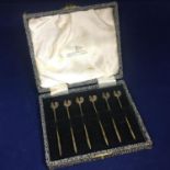 A vintage set of six sterling silver gilt cocktail sticks with cockerel finials, complete in