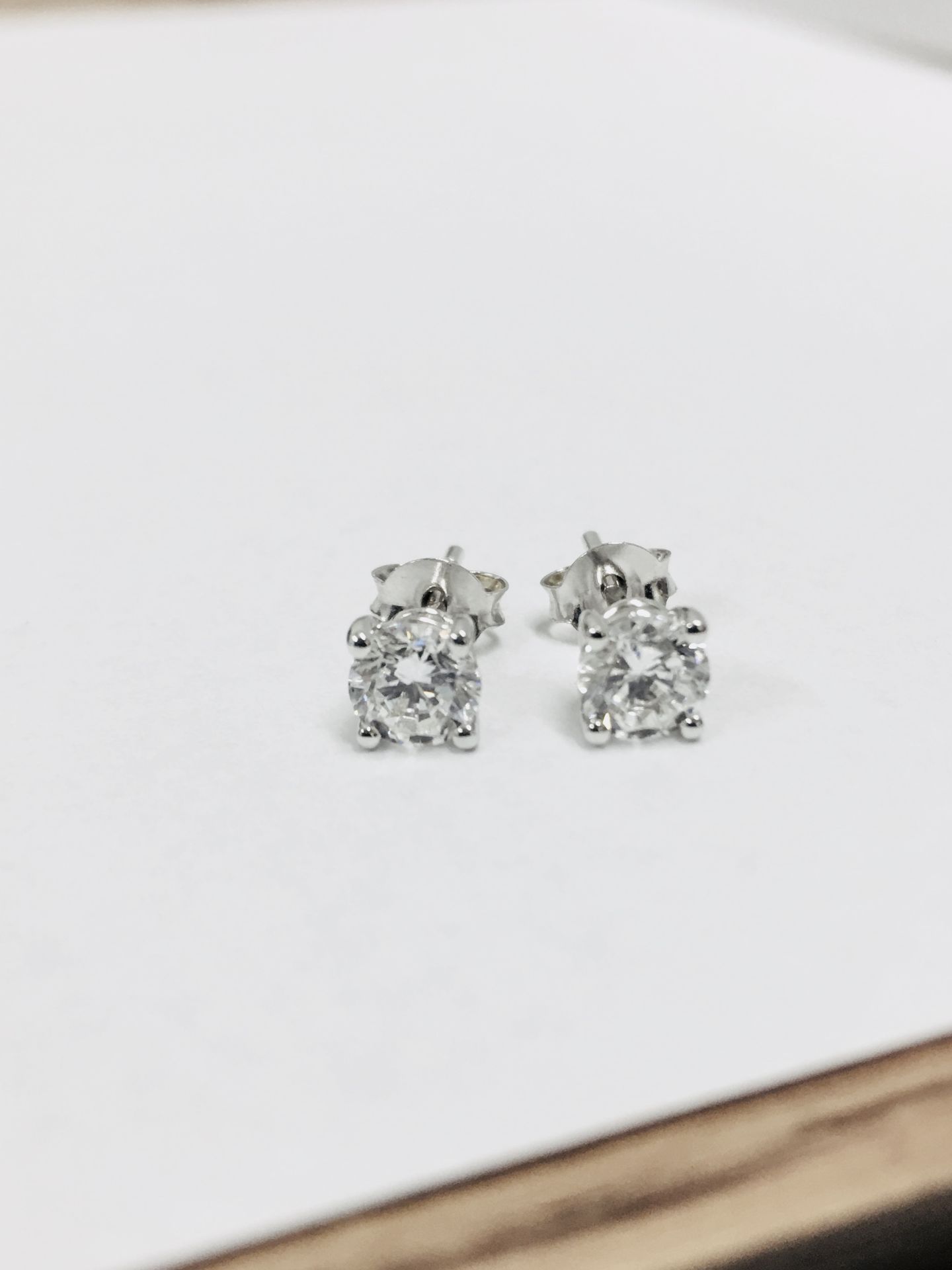 1.00ct diamond solitaire earrings set in platinum. 2 x brilliant cut diamonds, 0.50ct ( enhanced ) H