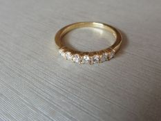 0.42ct diamond band ring set in 9ct yellow gold. 7 Small brilliant cut diamonds, I colour and i1